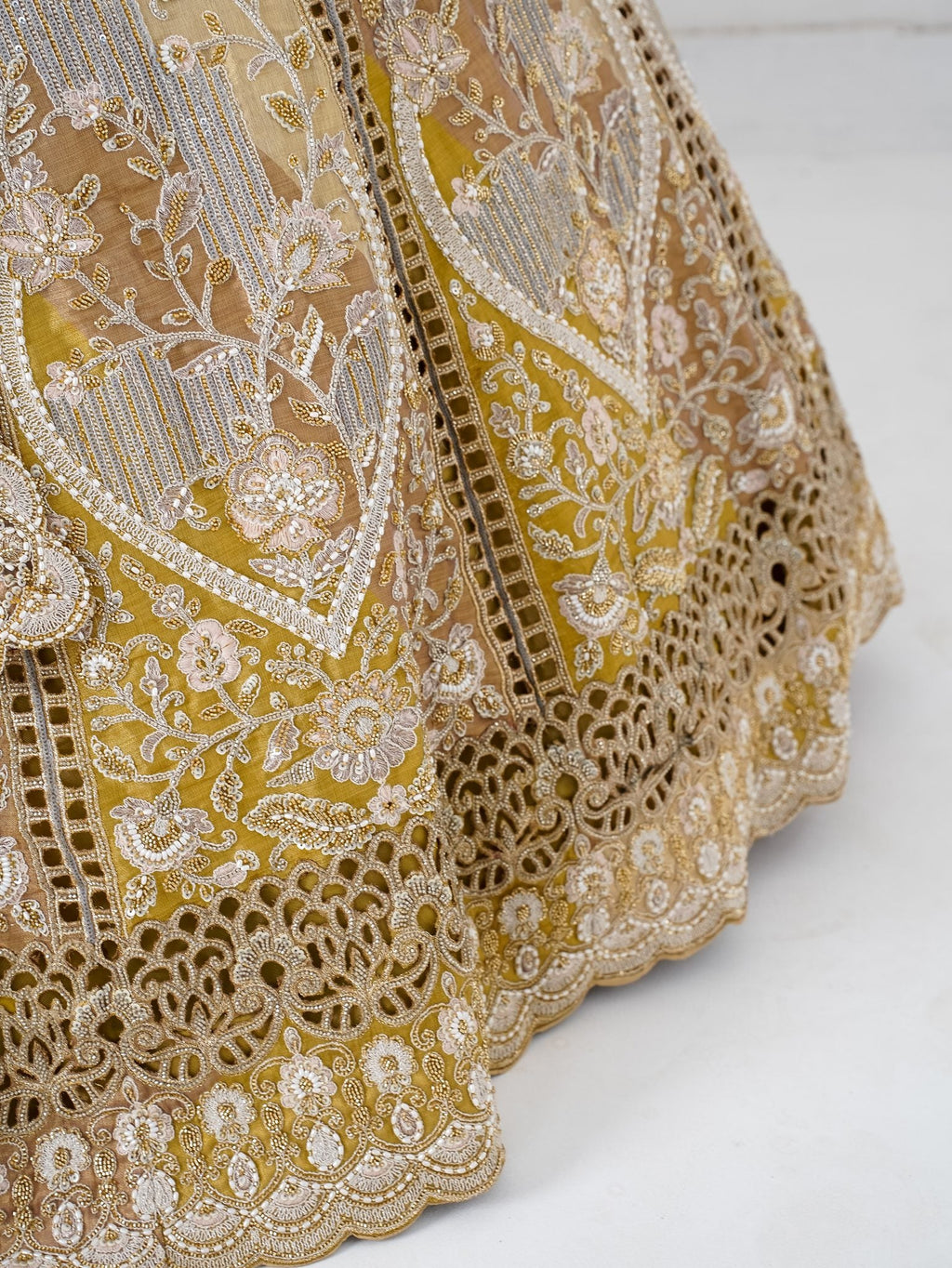 Antique gold cutwork lehenga, hem close-up