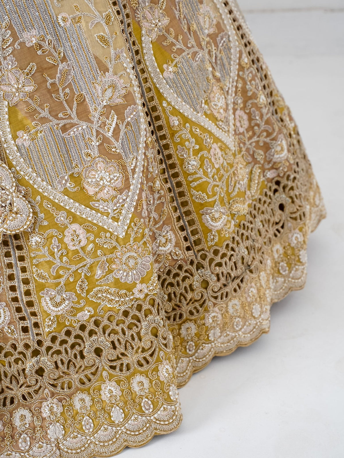 Antique gold cutwork lehenga, hem close-up