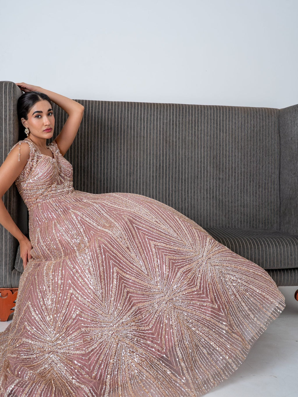 Blush sequin gown, seated, full length
