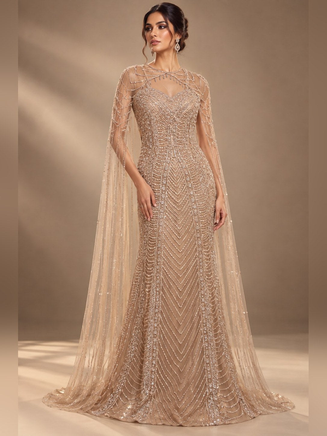 Champagne embellished gown with sheer cape sleeves