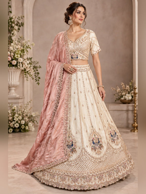 Ivory raw silk lehenga with peacock zardozi motifs and blush pink tissue dupatta
