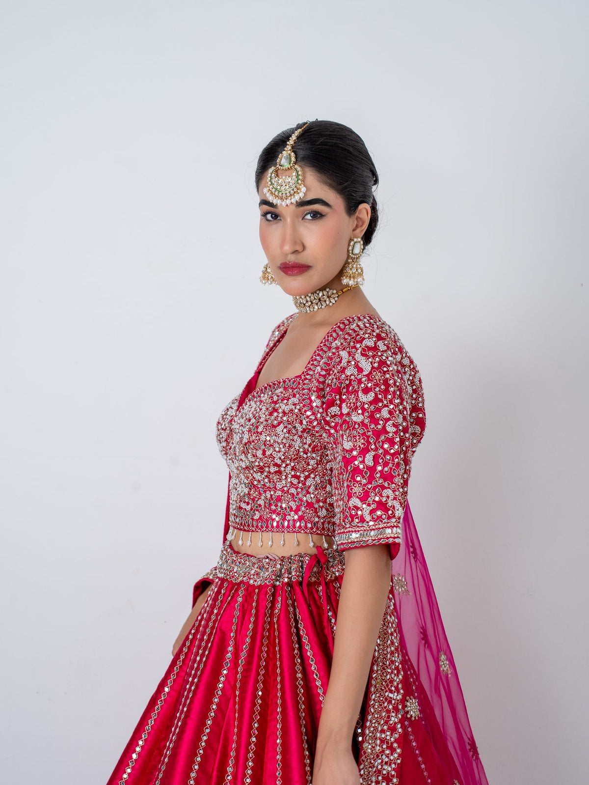 Magenta mirror-work lehenga, side view
