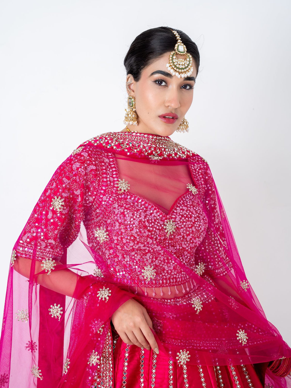 Magenta mirror-work lehenga, waist up