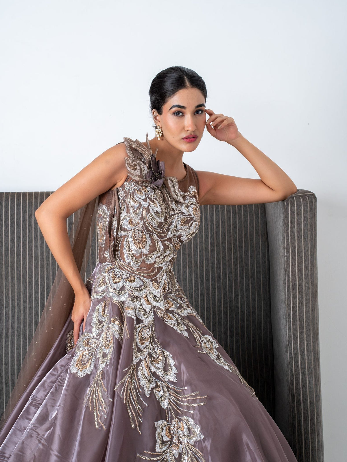 Mauve embellished gown, seated, full length