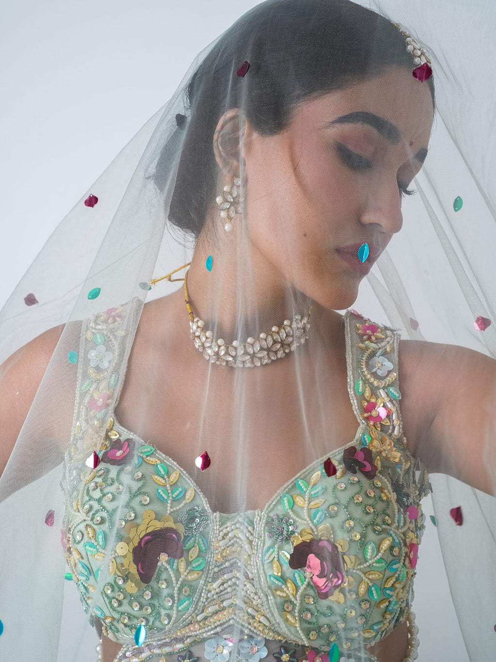 Mint floral appliqué lehenga, with the dupatta worn as a veil