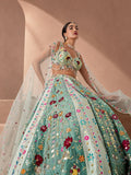 Model in a mint lehenga with multicolour floral appliqué and a sheer dupatta