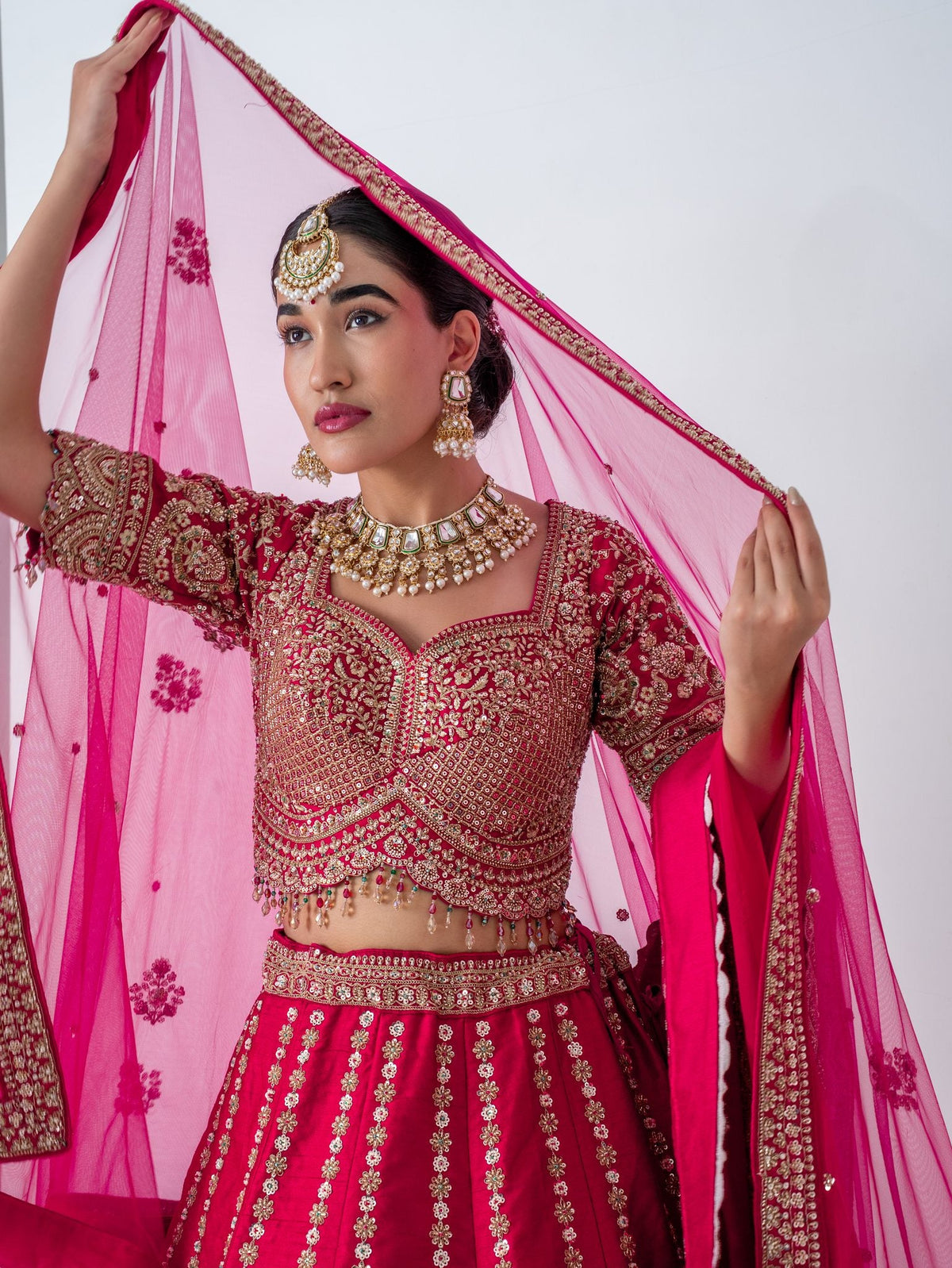 Red zari floral lehenga, with the dupatta worn as a veil